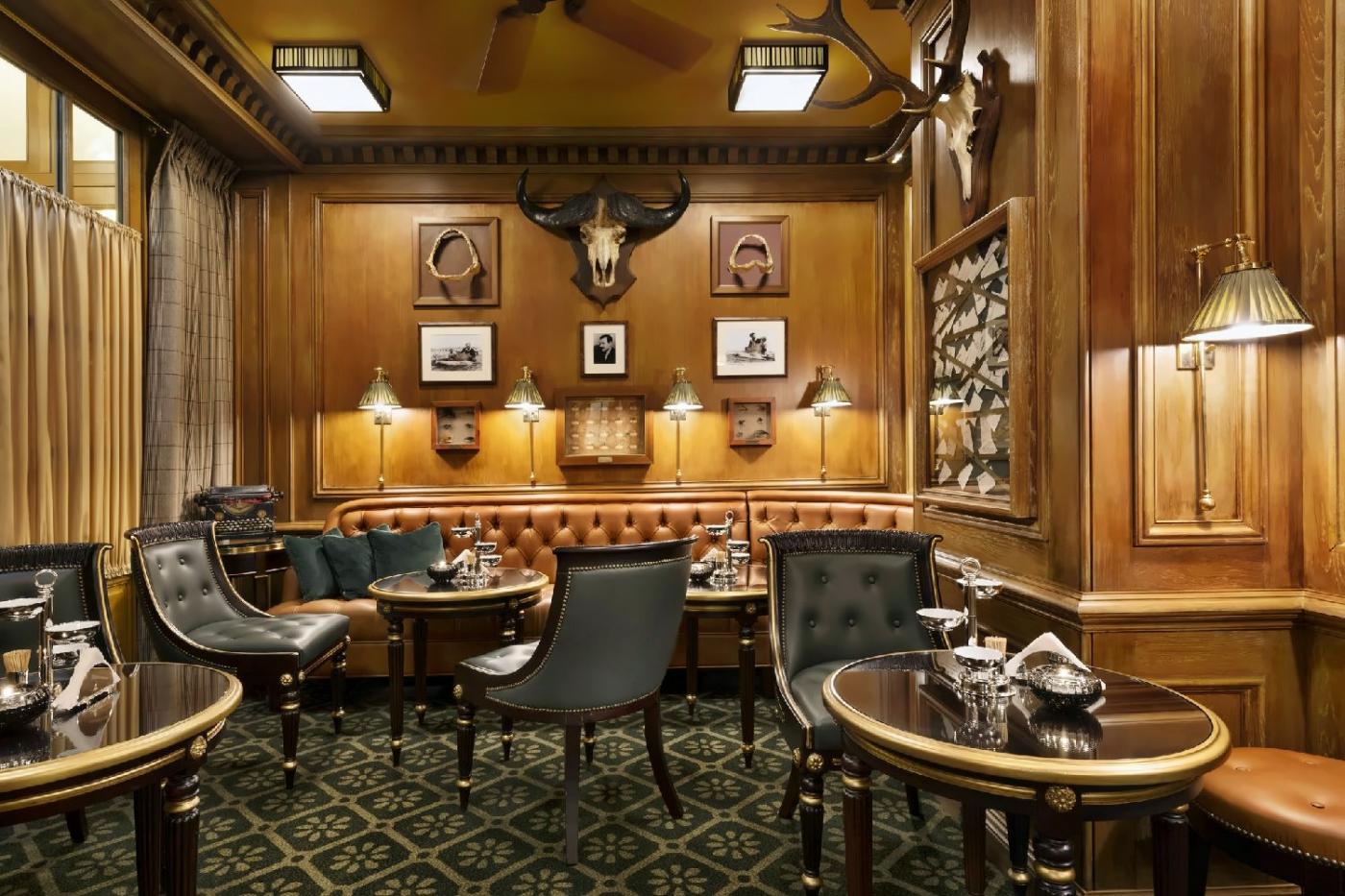 Bar Hemingway at Ritz Paris with wood paneling leather chairs and intimate cocktail-bar light