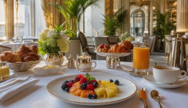Luxury hotel breakfast with pastries, fruit, coffee and morning light