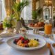 Luxury hotel breakfast with pastries, fruit, coffee and morning light