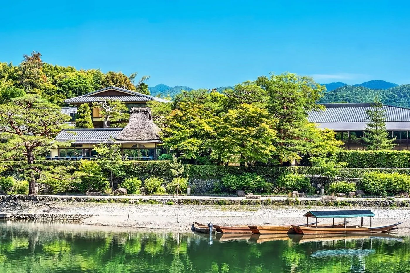 Suiran Kyoto beside the river and wooded hills of Arashiyama