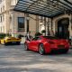 Ferrari and Lamborghini arriving at a luxury hotel in daylight