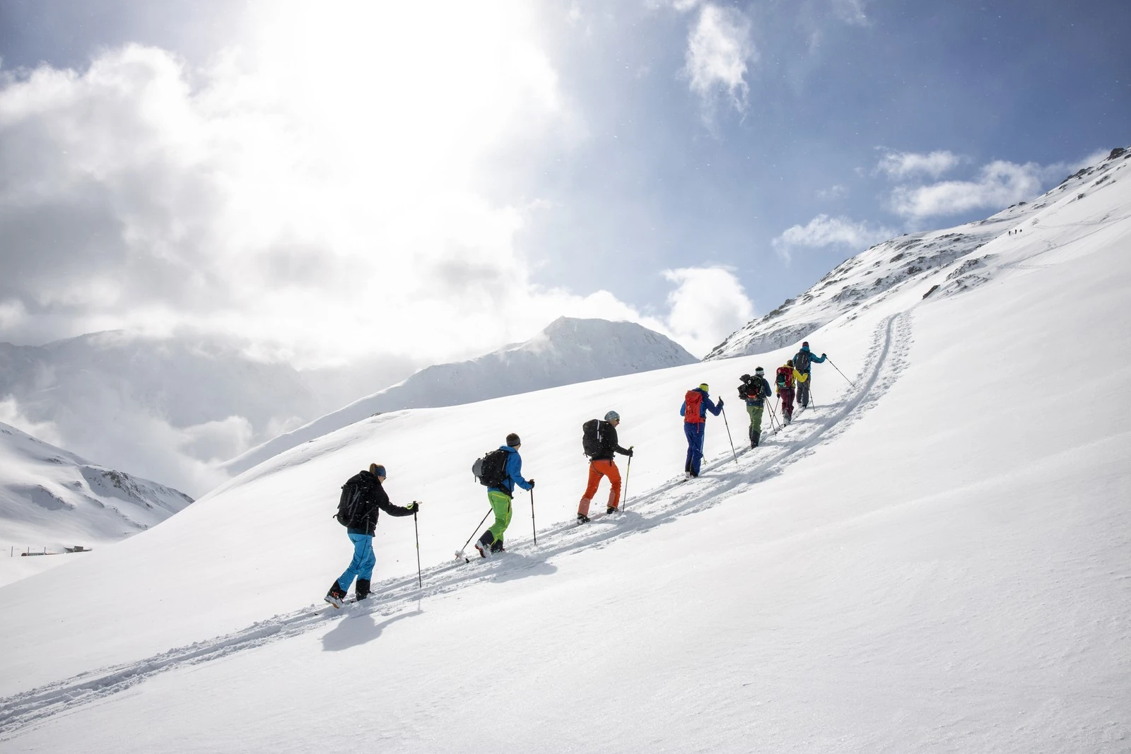 Group walking on snowshoes through the snowy mountains near Andermatt