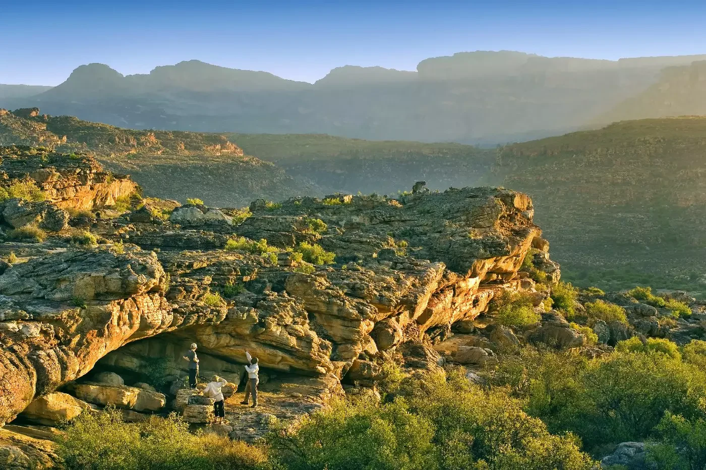Layered sandstone formations and mountain slopes in the Bushmans Kloof reserve