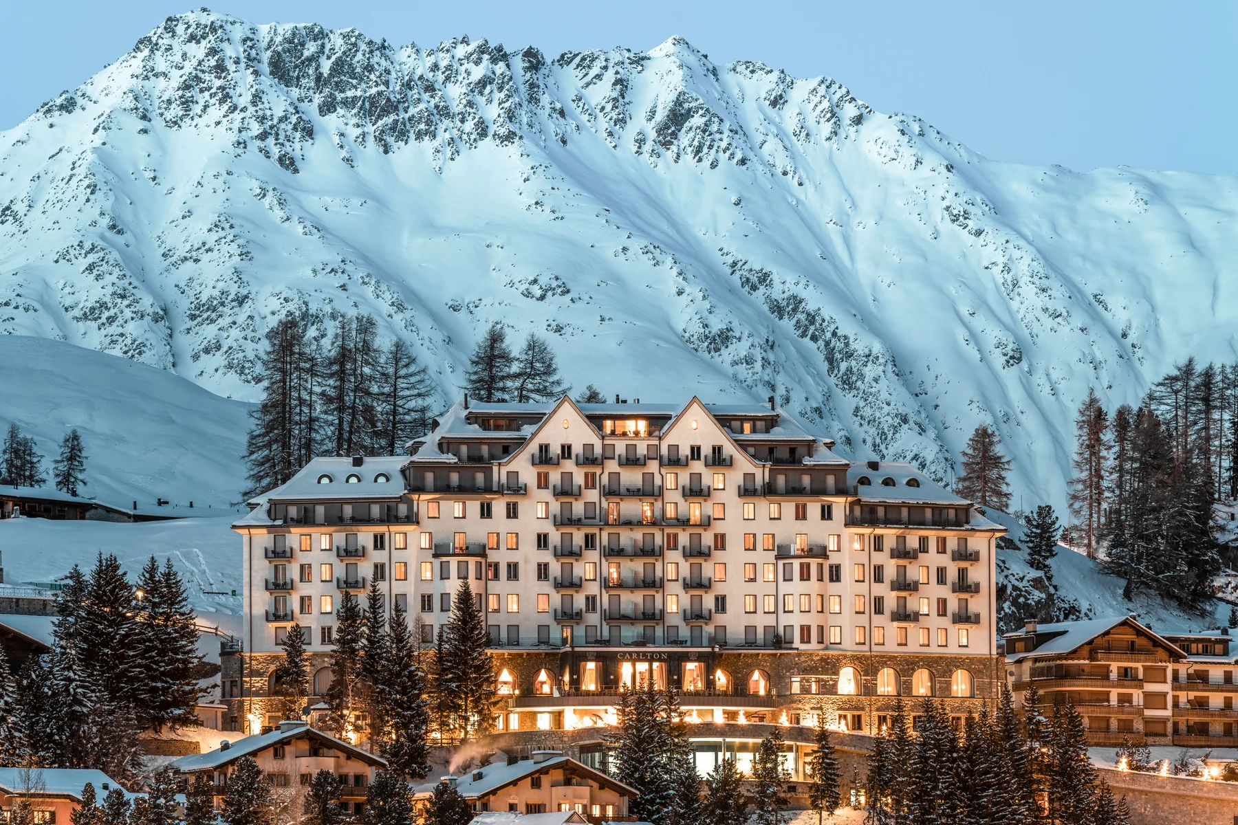 Carlton Hotel St. Moritz facade against the snow-covered Engadin mountains