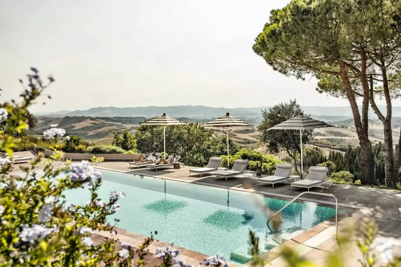 Outdoor pool and loungers overlooking the hills at Castelfalfi