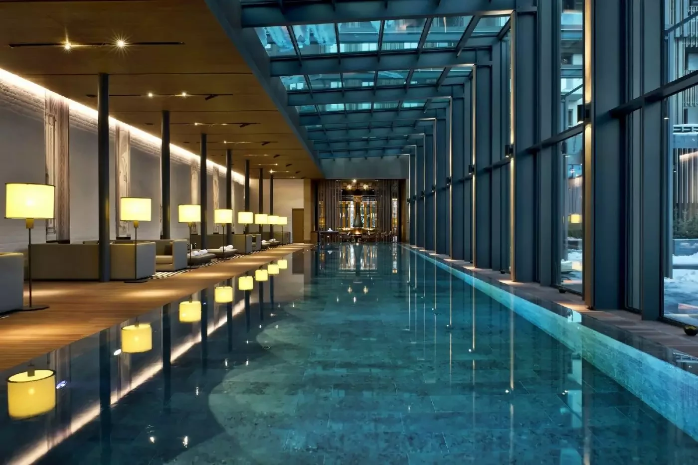 Long indoor pool beside floor-to-ceiling windows at The Chedi Andermatt