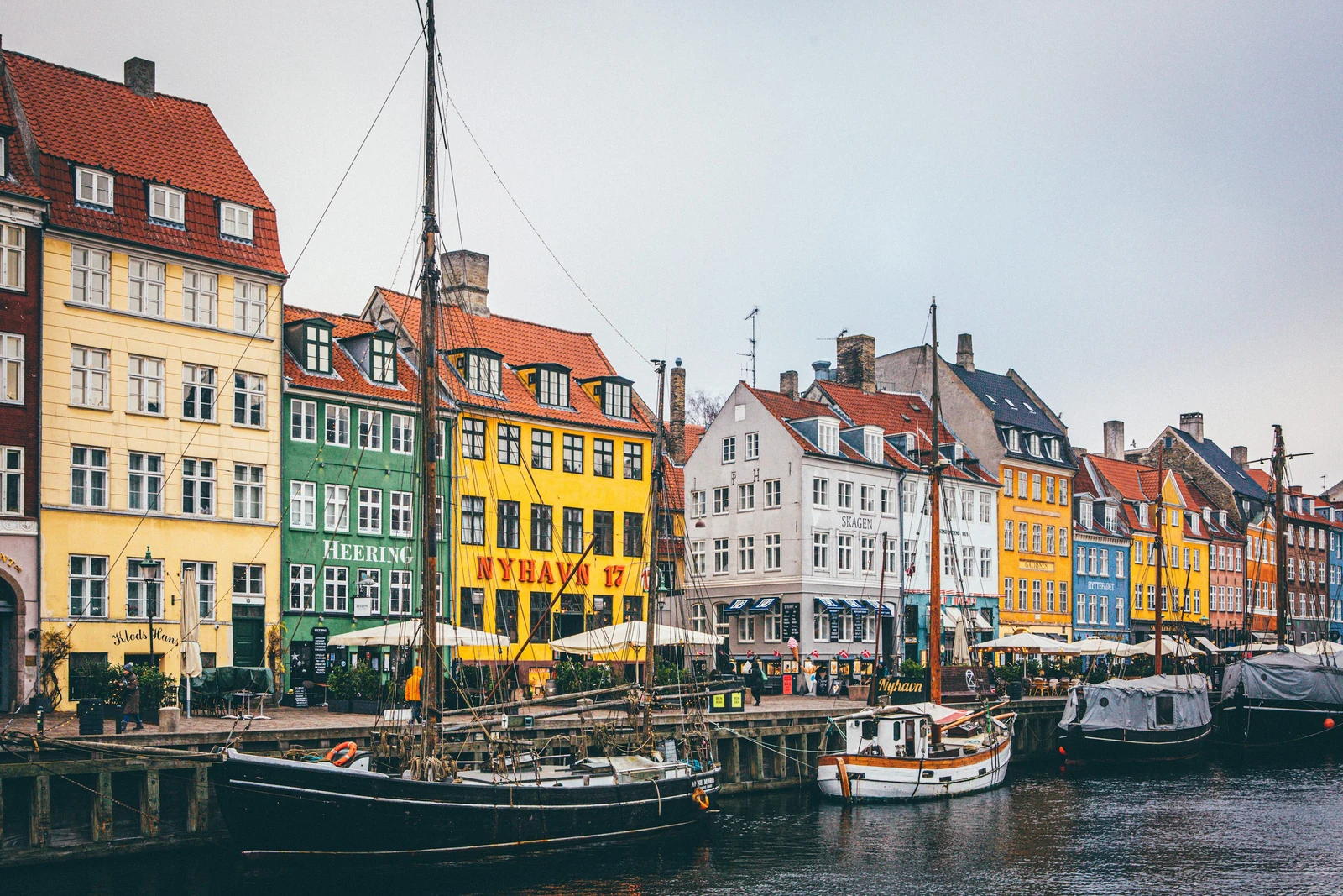 Colorful Nyhavn waterfront houses and moored boats in Copenhagen