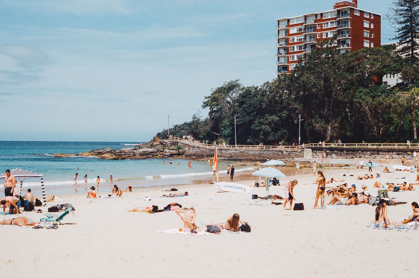 Beachgoers at the southern end of Manly Beach beside the coastal promenade