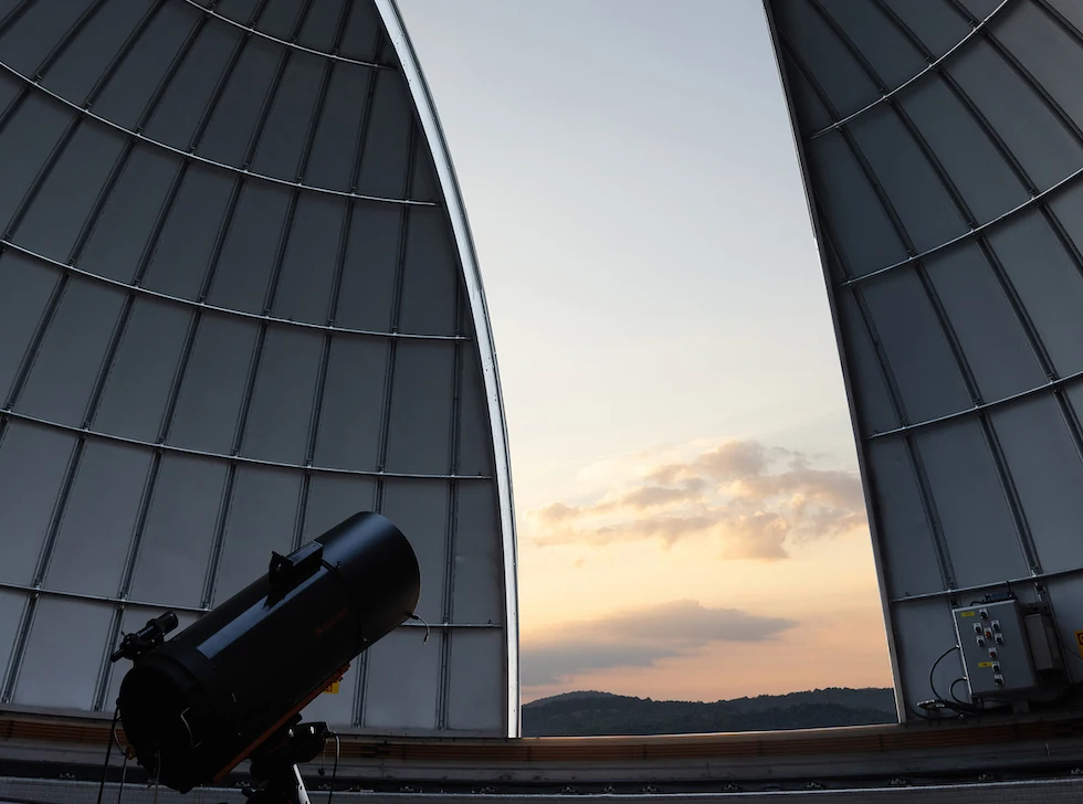 Telescope inside the open observatory dome at The Lodge at Primland at dusk