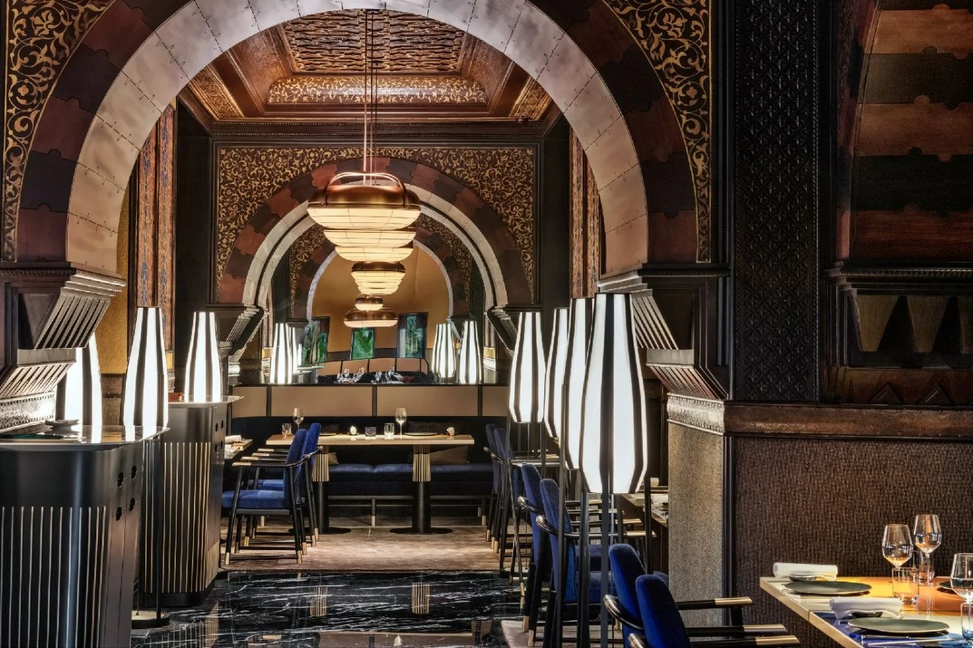 Arched dining room with table settings at La Mamounia