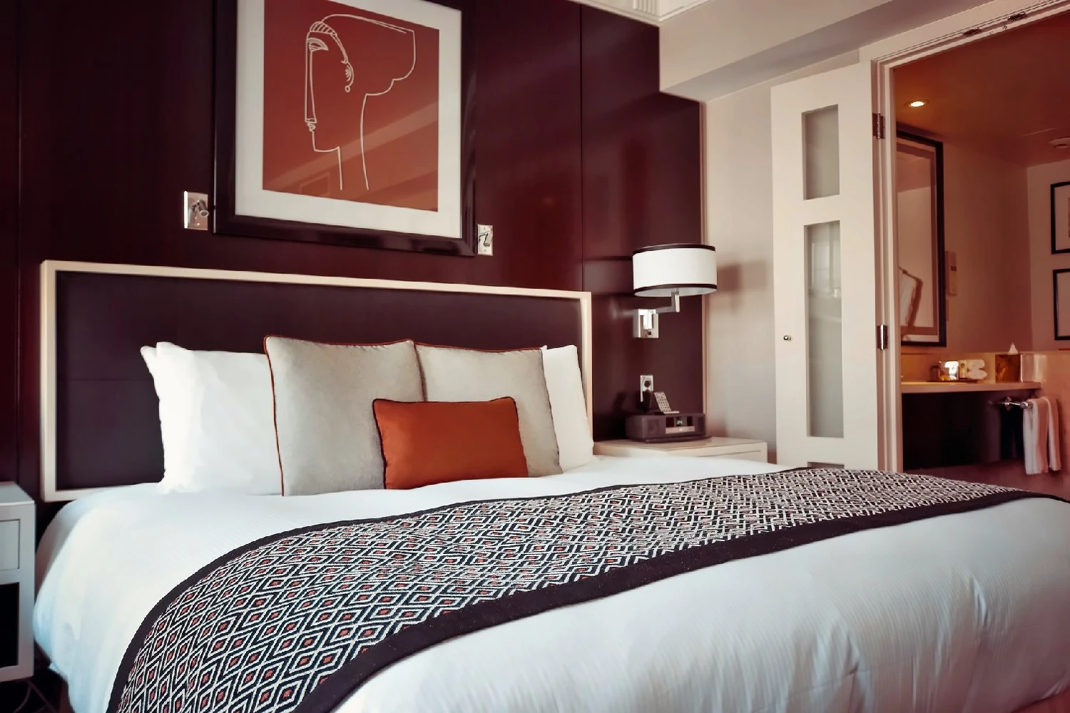 Hotel bedroom with a king bed and upholstered headboard