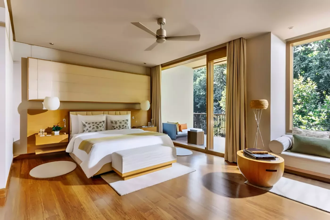 Bedroom at Six Senses Vana with pale furnishings and windows facing trees