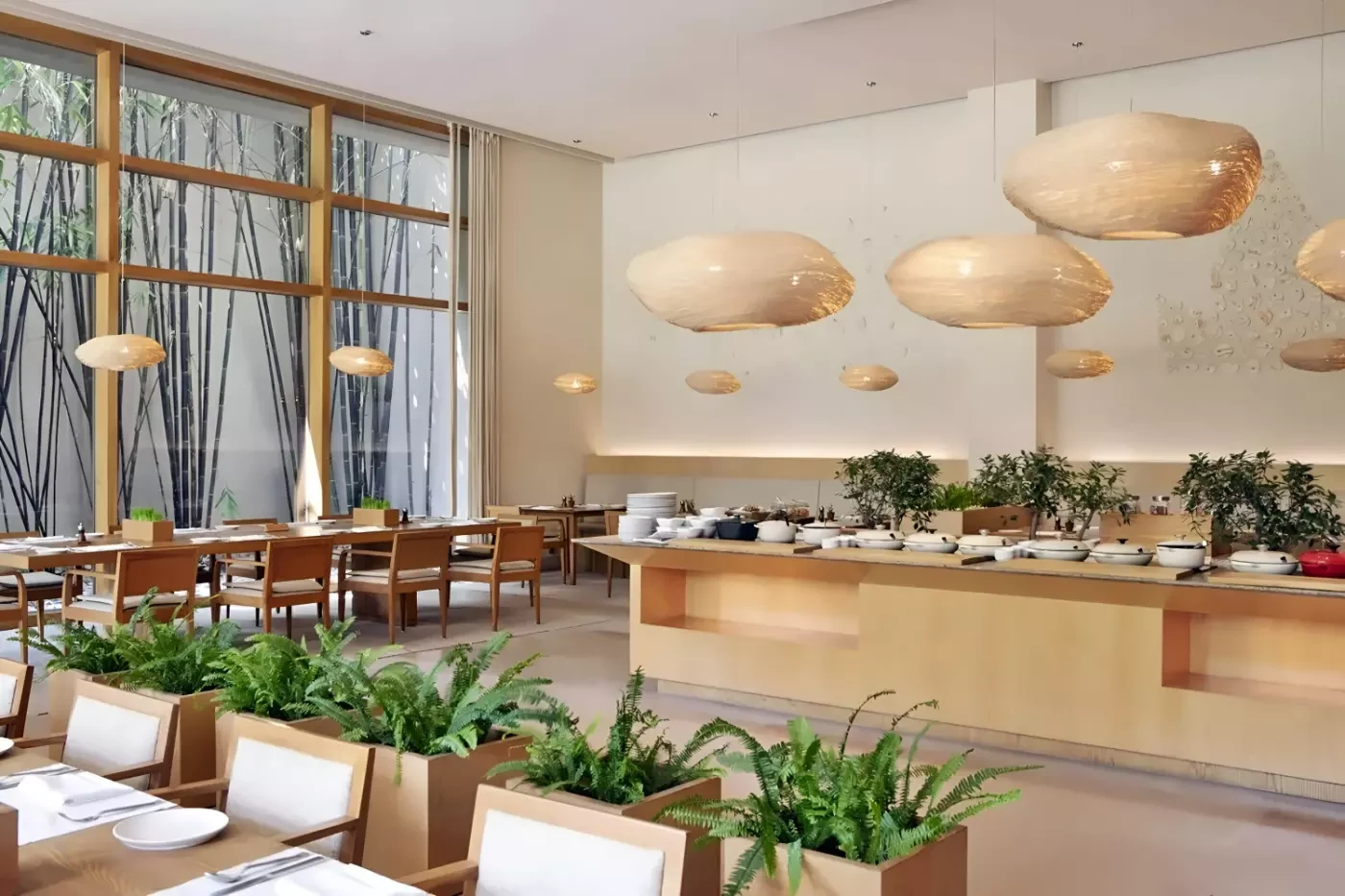 Dining room at Six Senses Vana with large windows and hanging pendant lights