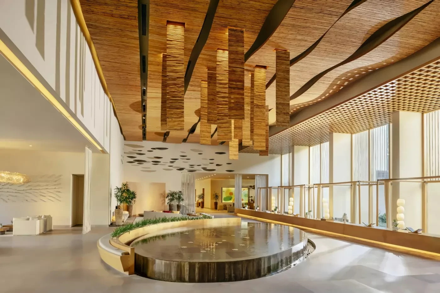 Light-filled interior at Six Senses Vana with timber ceiling details and a circular water feature