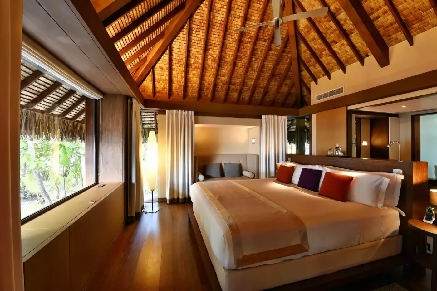 Light-filled villa bedroom at The Brando with timber furniture and garden views
