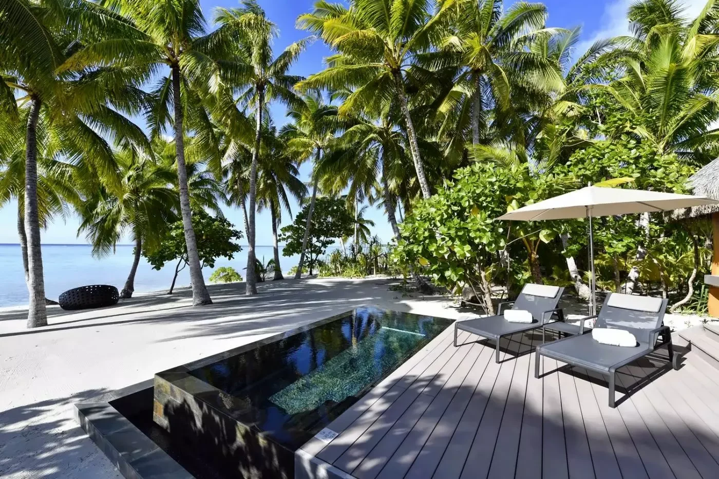 Private pool and shaded deck beside a villa at The Brando