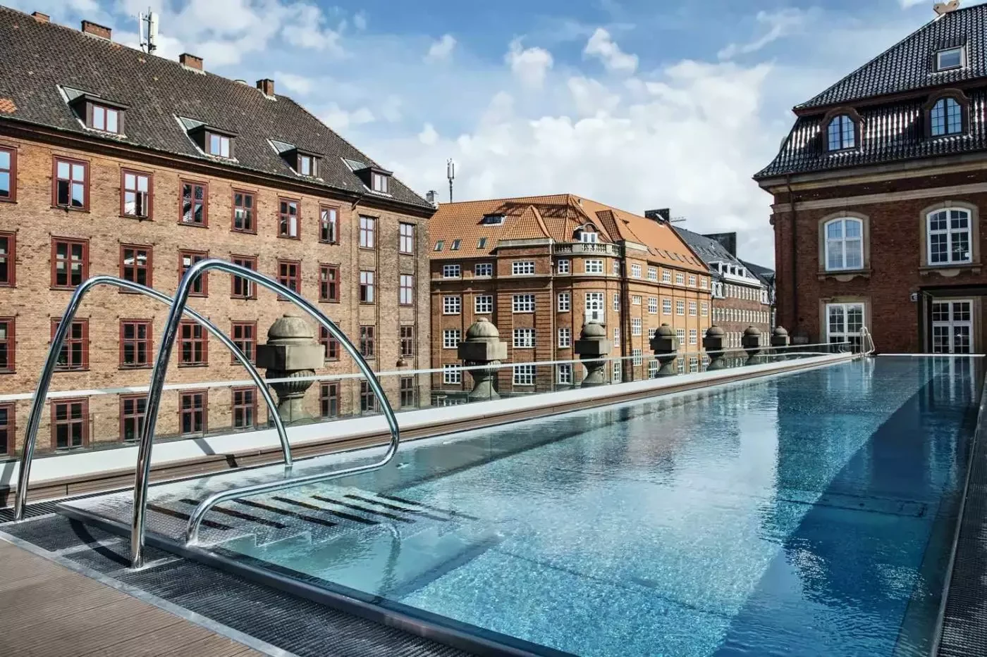 Outdoor swimming pool surrounded by the historic buildings of Villa Copenhagen